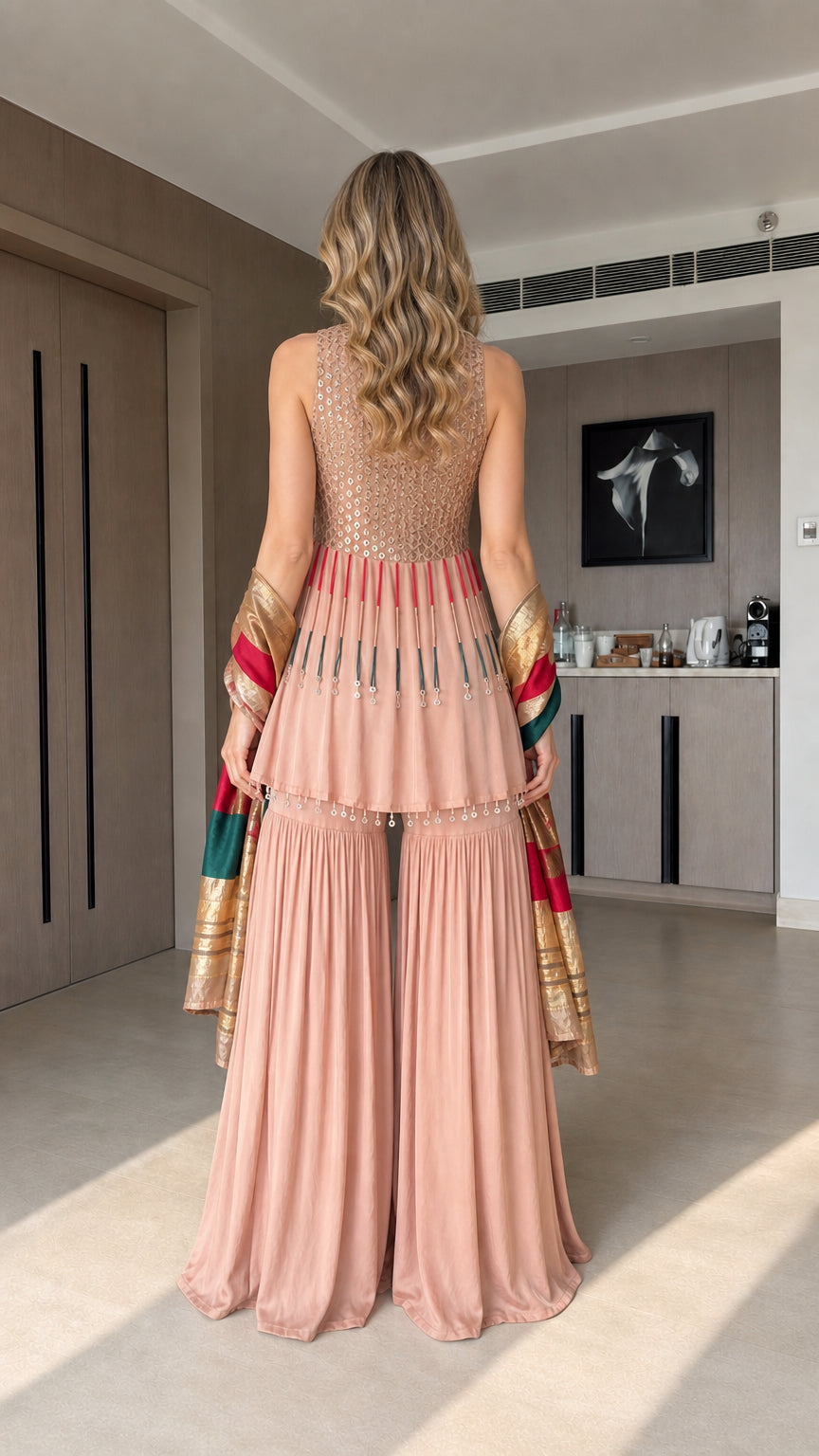 Back view of blush pink sleeveless sharara suit set with flared silhouette