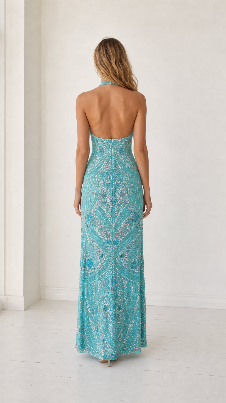 Back view showing open back and halter straps of turquoise dress