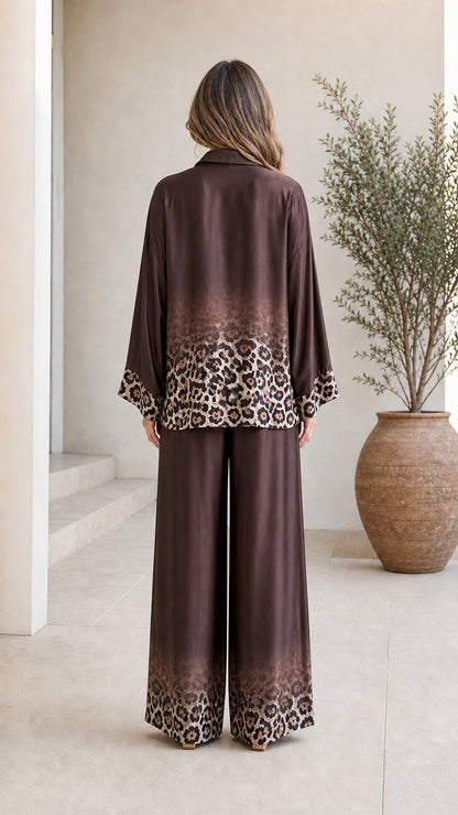 Back view of woman in brown satin leopard ombre pant set