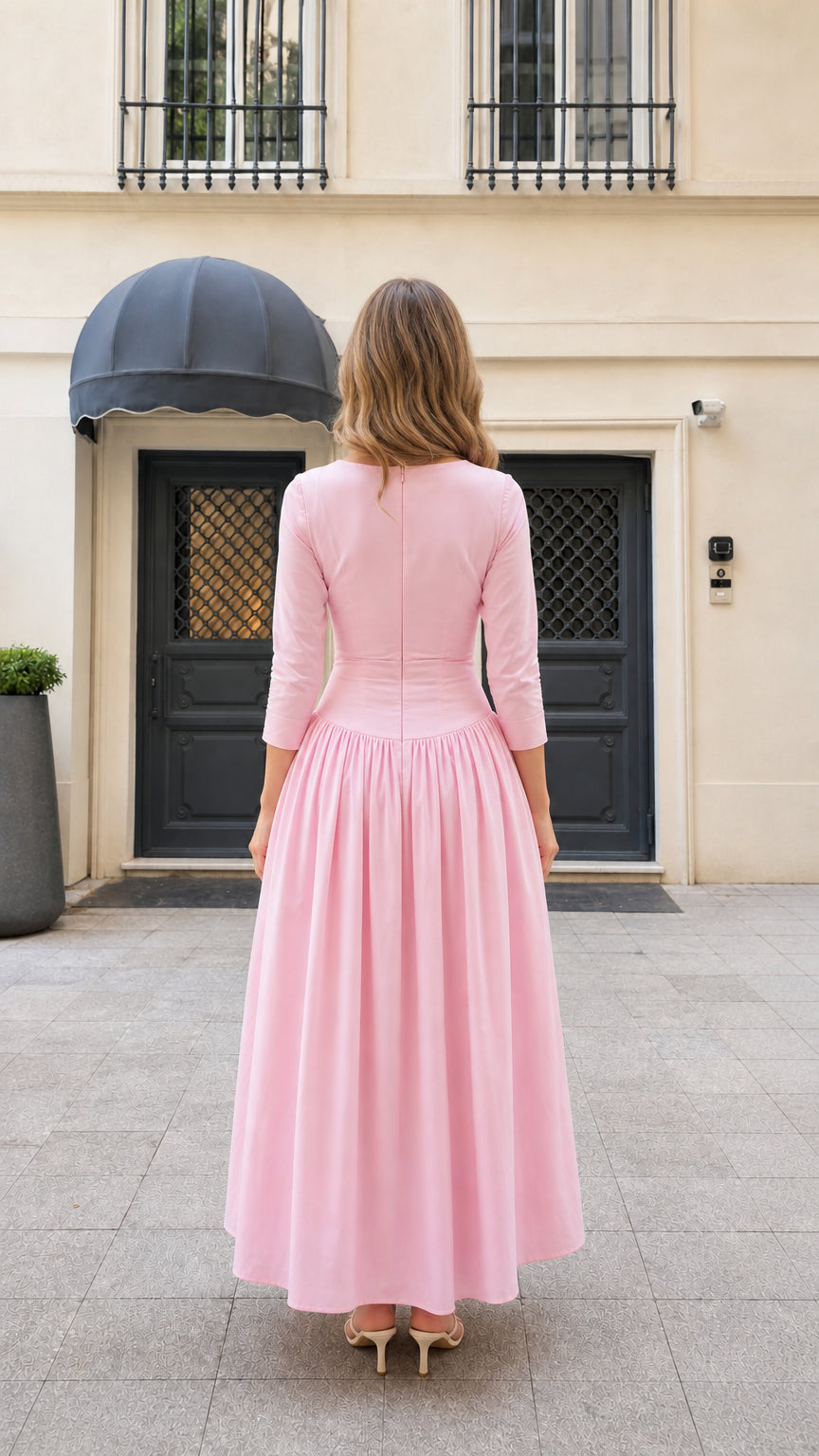Back view of model wearing pink tailored maxi dress with gathered skirt