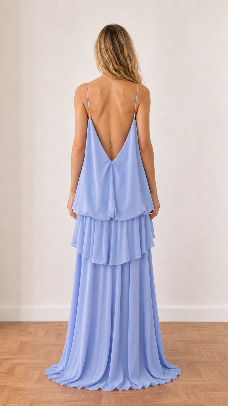 Back view of model showing open back detail of Light Blue maxi dress