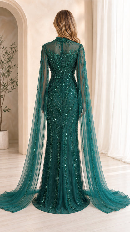 Back view of emerald green gown with flowing cape