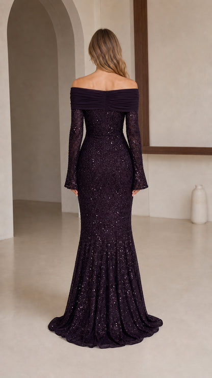 Model wearing dark plum evening gown, back view