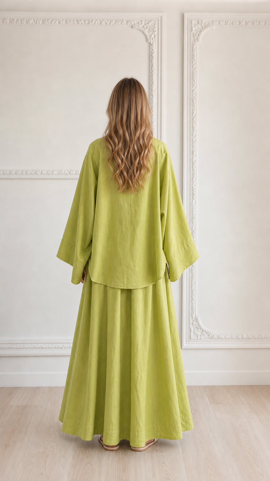 Back view of woman wearing flowing lime green 2-piece lounge set