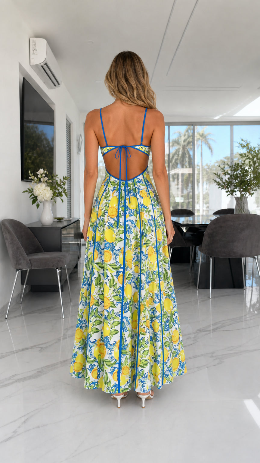 Back view showing lace-up open back details of the lemon print dress