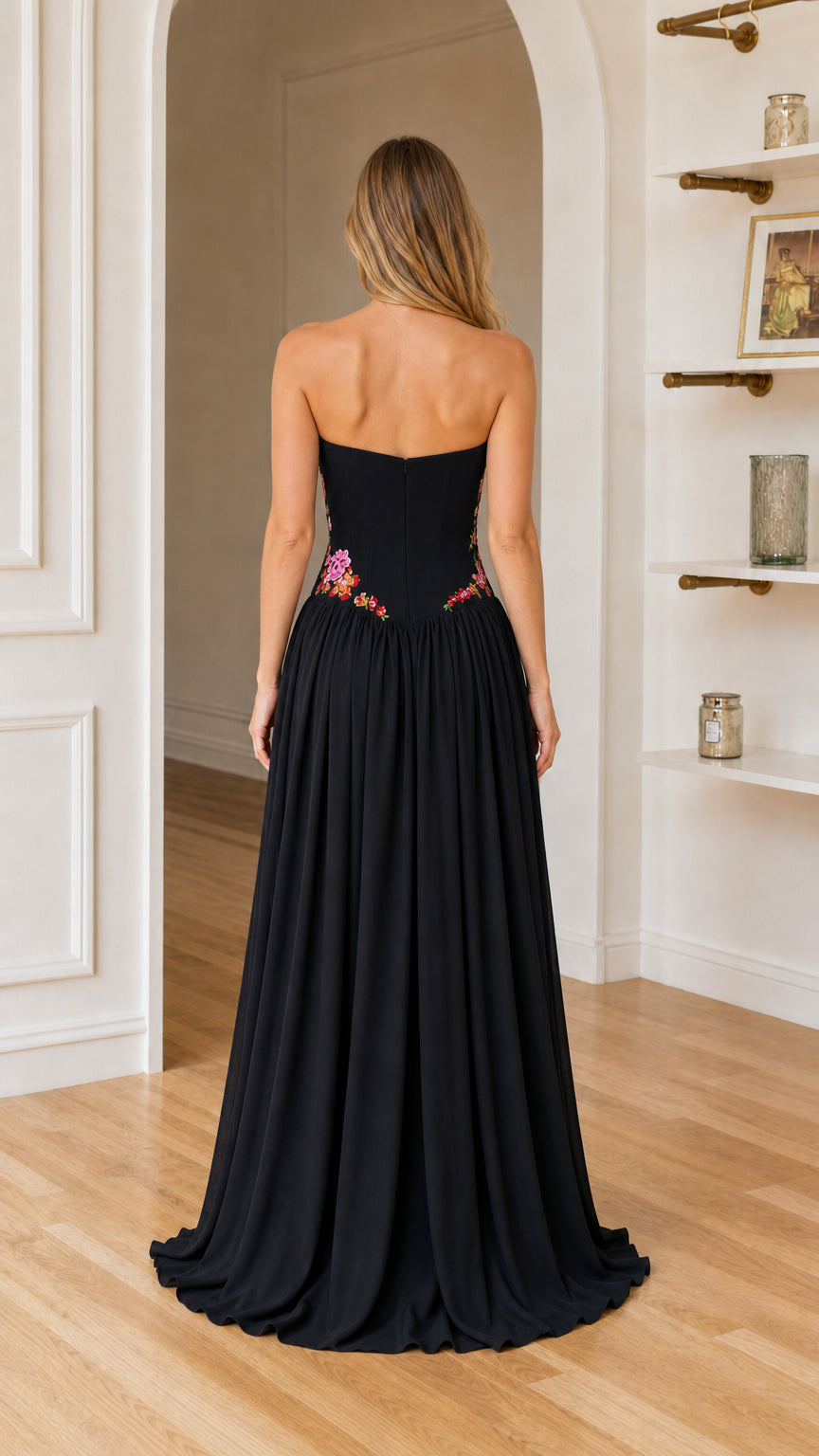 Back view of woman showing sweeping hemline of black maxi dress