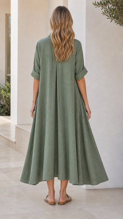 Back view of woman showing relaxed fit and pleat detail on sage green dress
