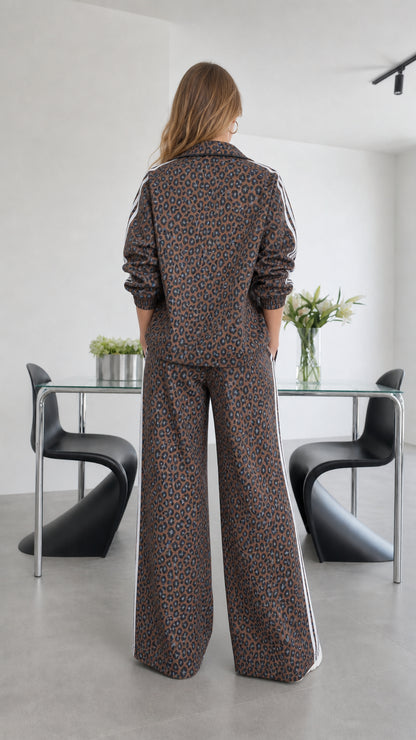 Back view of model showing back of leopard print jacket and trousers