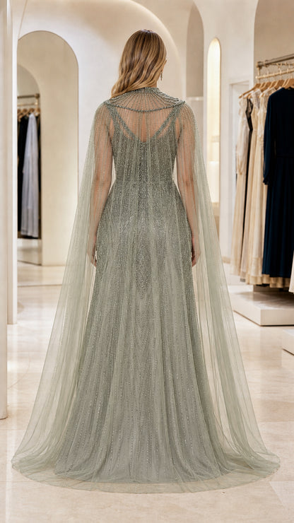 Back view of Sage Green beaded cape gown showcasing delicate sheer tulle drape