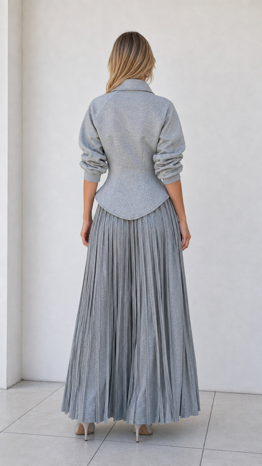 Back view of model wearing heather grey structured jacket top and flowy wide-leg pants