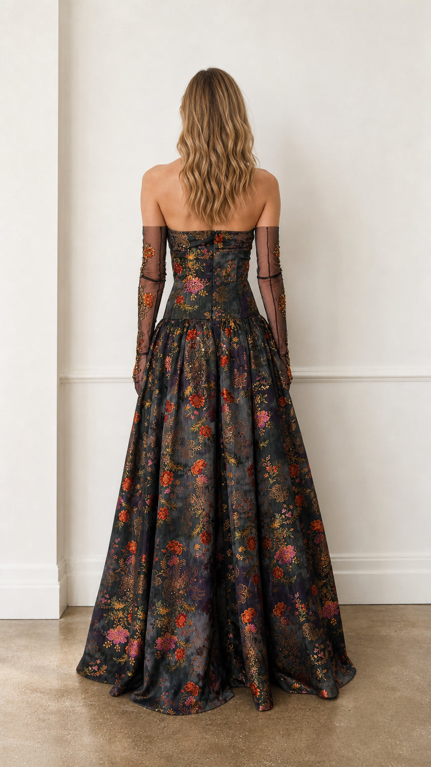 Back view of charcoal floral gown highlighting back structure and skirt volume