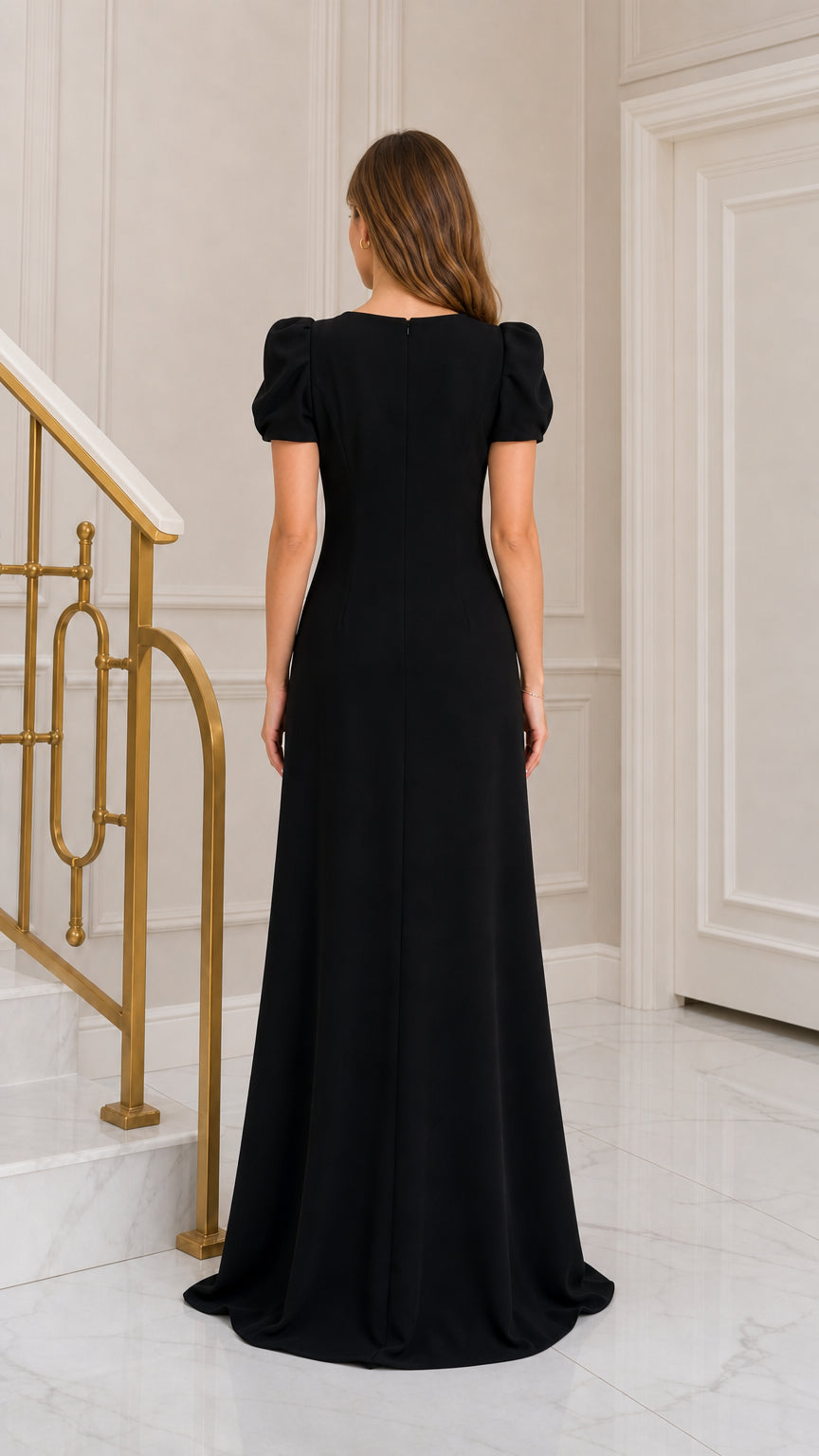 Back view of woman wearing elegant black floor-length dress showing clean back silhouette