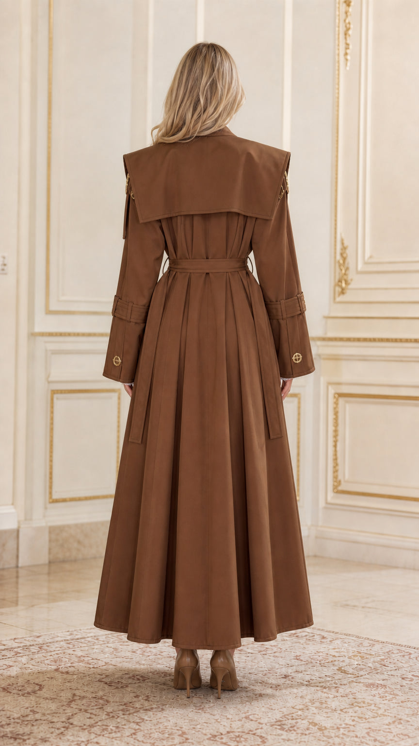 Back view of brown maxi trench coat showing flared hem and storm flap