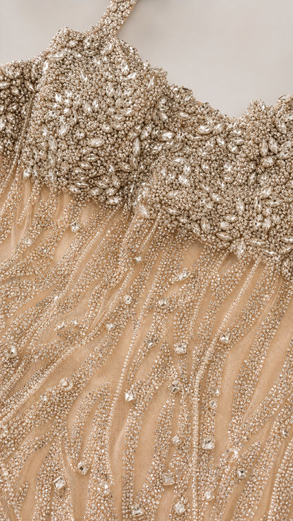 Close-up detail of crystal and bead embellishments on bodice