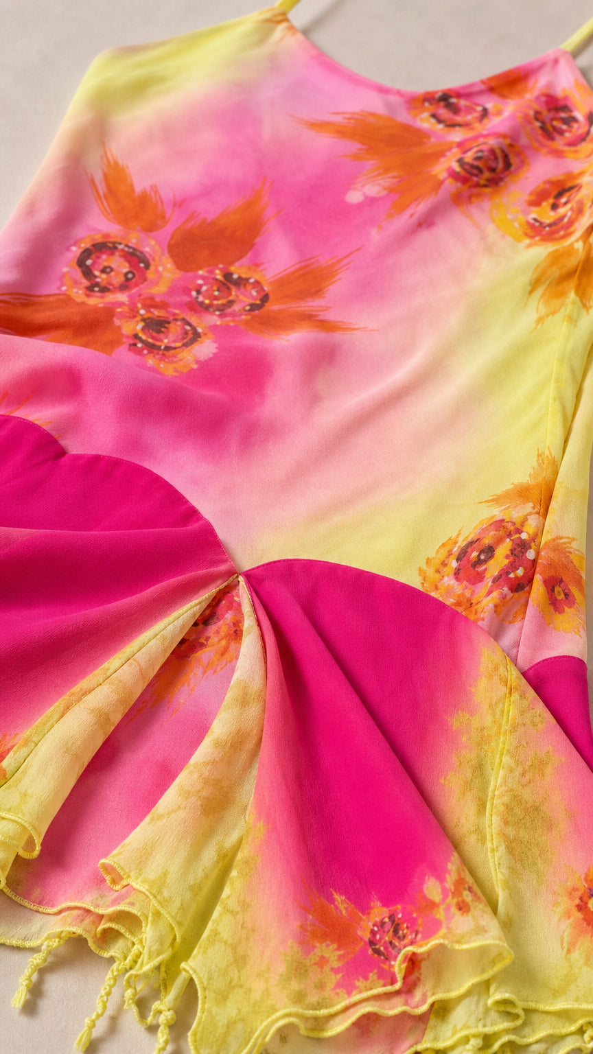 Close-up detail of floral print and asymmetric hem on Yellow Pink dress
