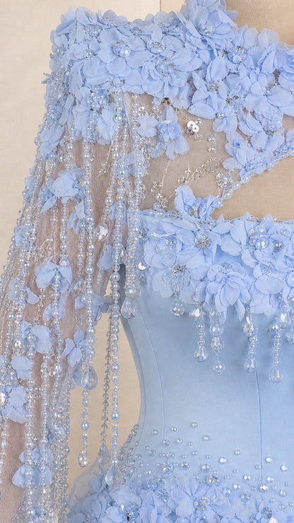 Close-up of floral appliques and beaded fringe on light blue gown