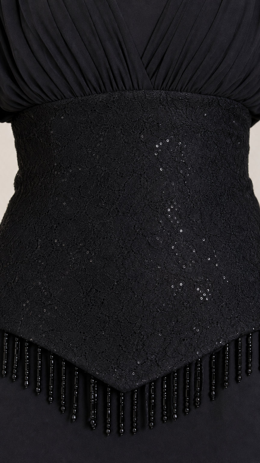 Close-up detail of textured sequin waistband with delicate beaded fringe trim