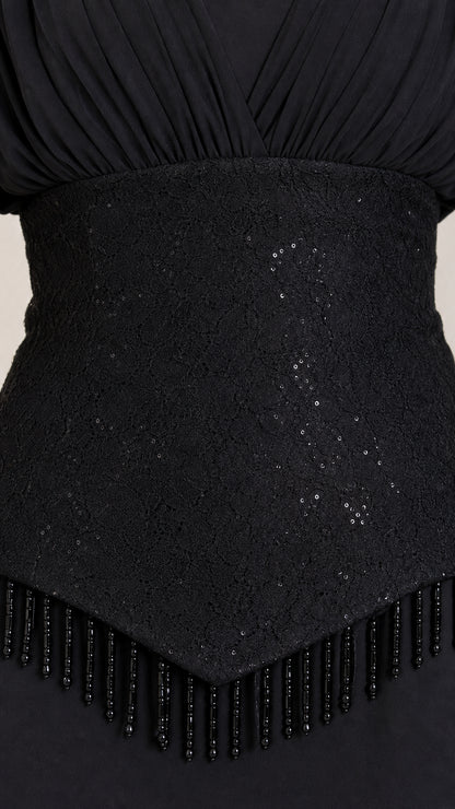 Close-up detail of textured sequin waistband with delicate beaded fringe trim