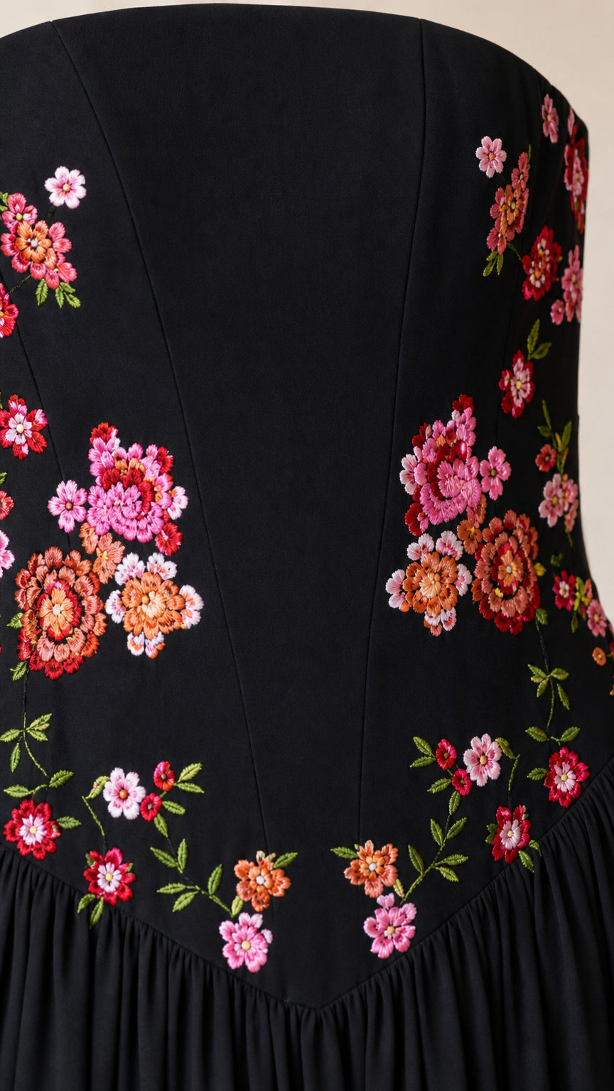 Close-up detail of colorful floral embroidery on black bodice