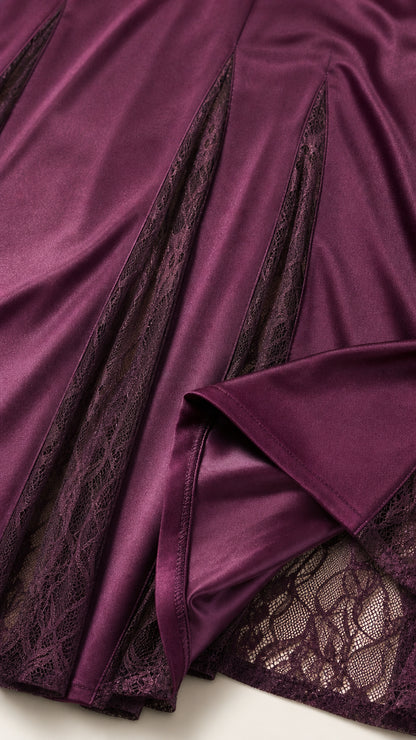 Close up of lace godet panel on plum satin dress