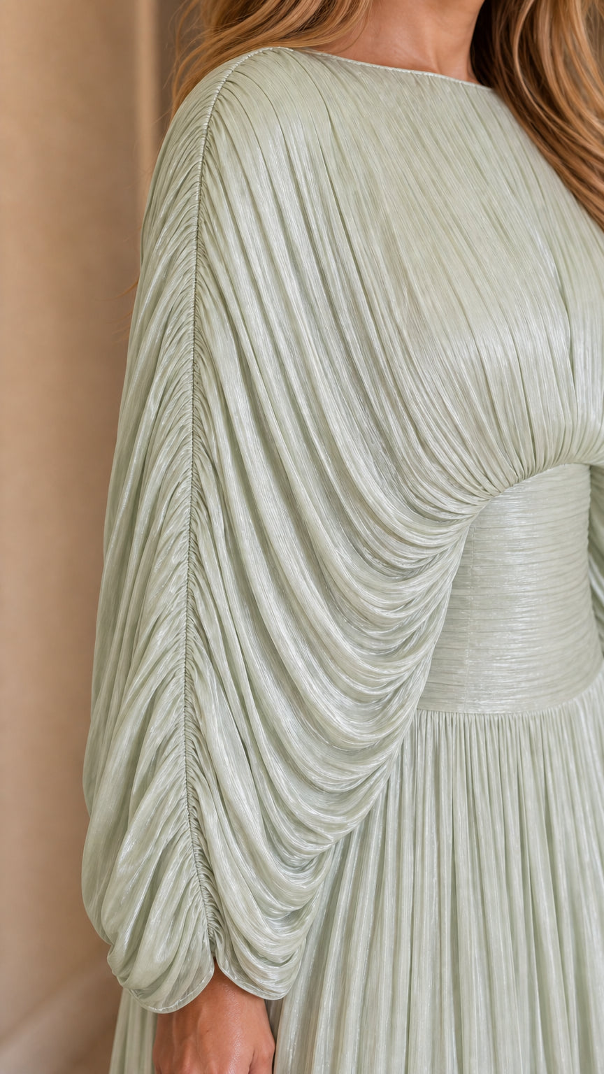 Close-up detail of the draped sleeves and pleated texture