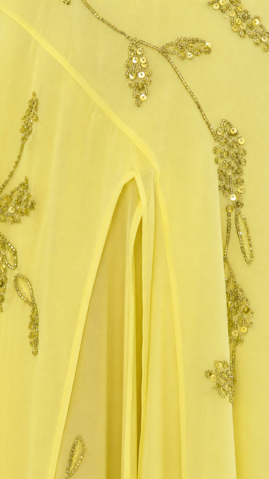 Close-up detail of sequin vine embroidery and front slit