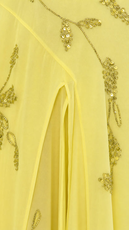 Close-up detail of sequin vine embroidery and front slit