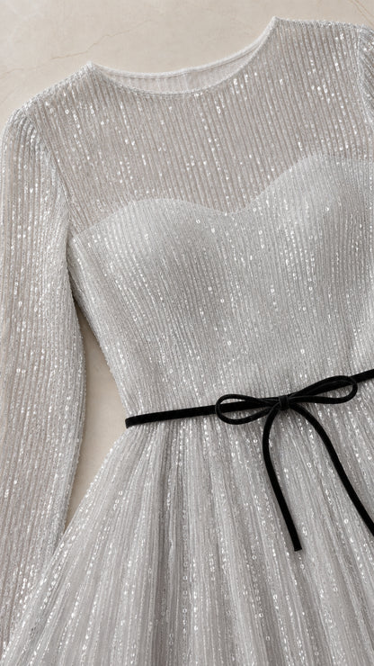 Close-up detail of bodice, round neckline, sleeves, and velvet bow belt
