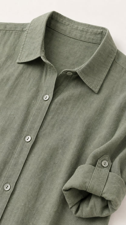 Close-up of collar, button placket, and roll-tab sleeve on sage green dress