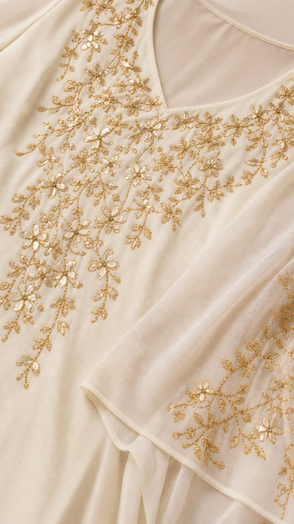 Close-up of gold floral metallic embroidery and beading on chiffon neckline