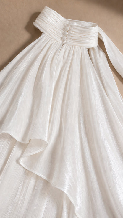Close up of high collar and button detail on white dress