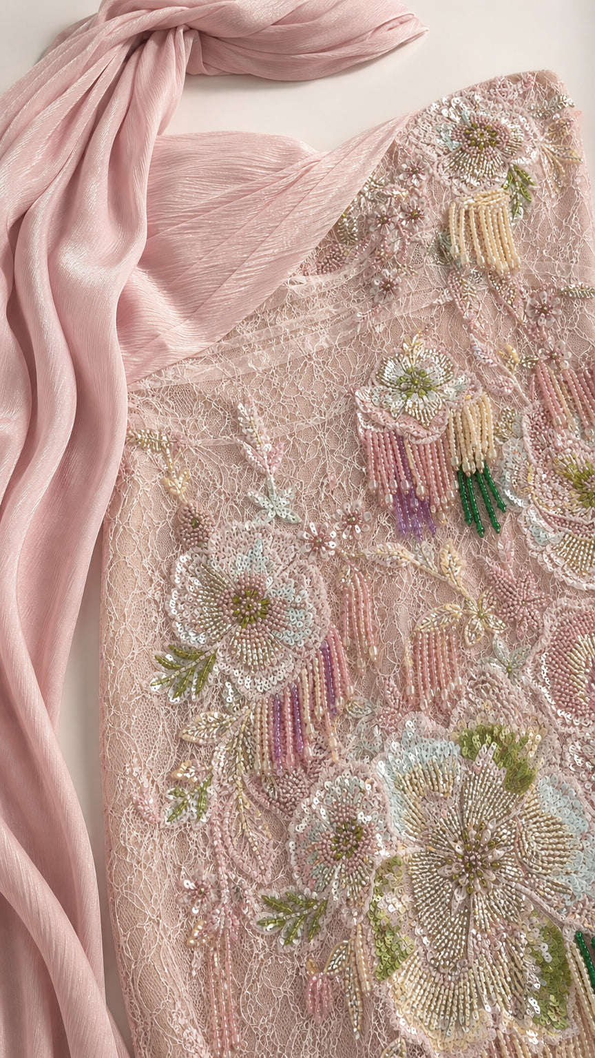 Close-up detail of floral beadwork and sheer scarf