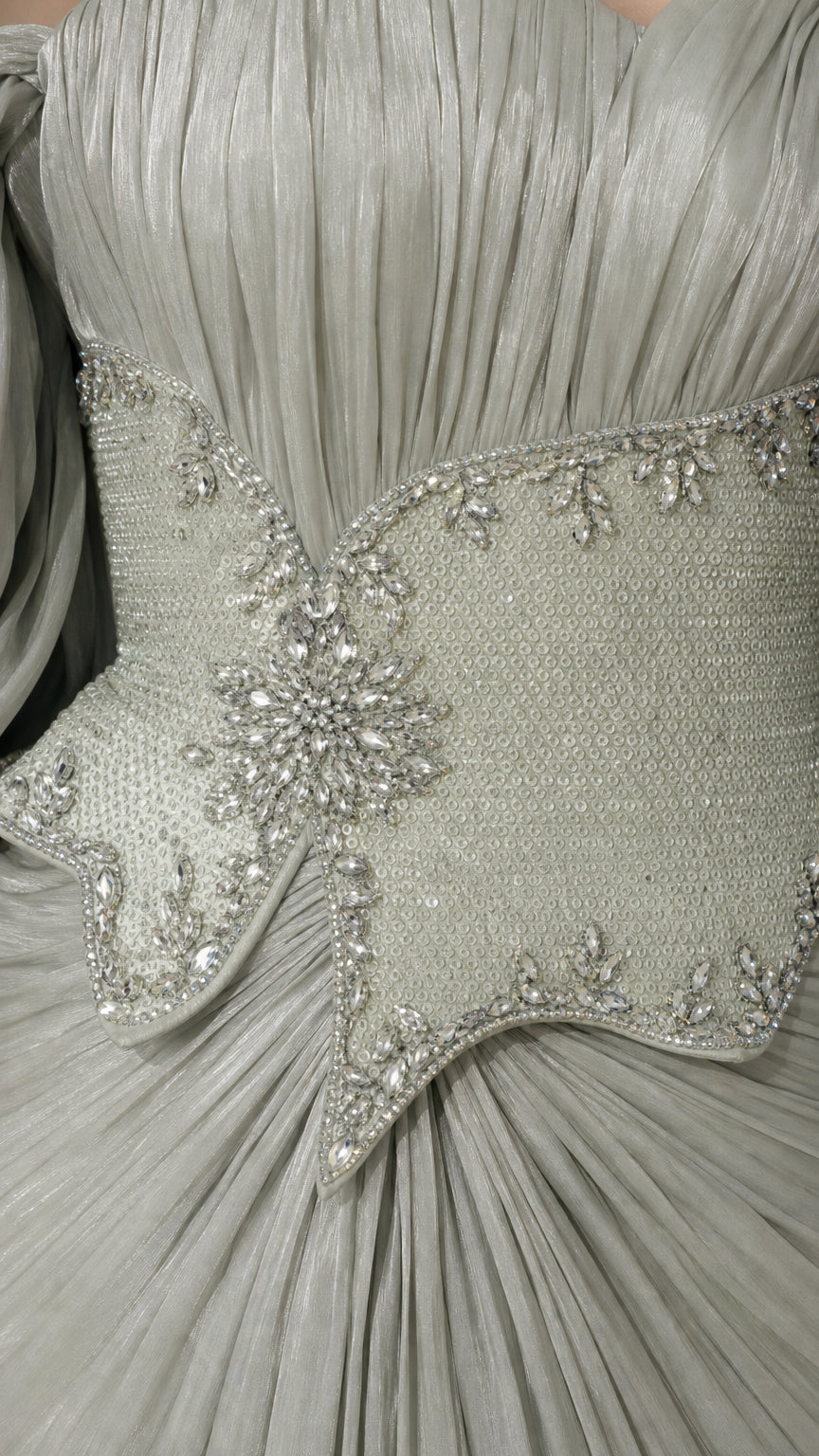 Close-up detail of Sage Green pleated bodice with crystal-embellished basque waist cincher