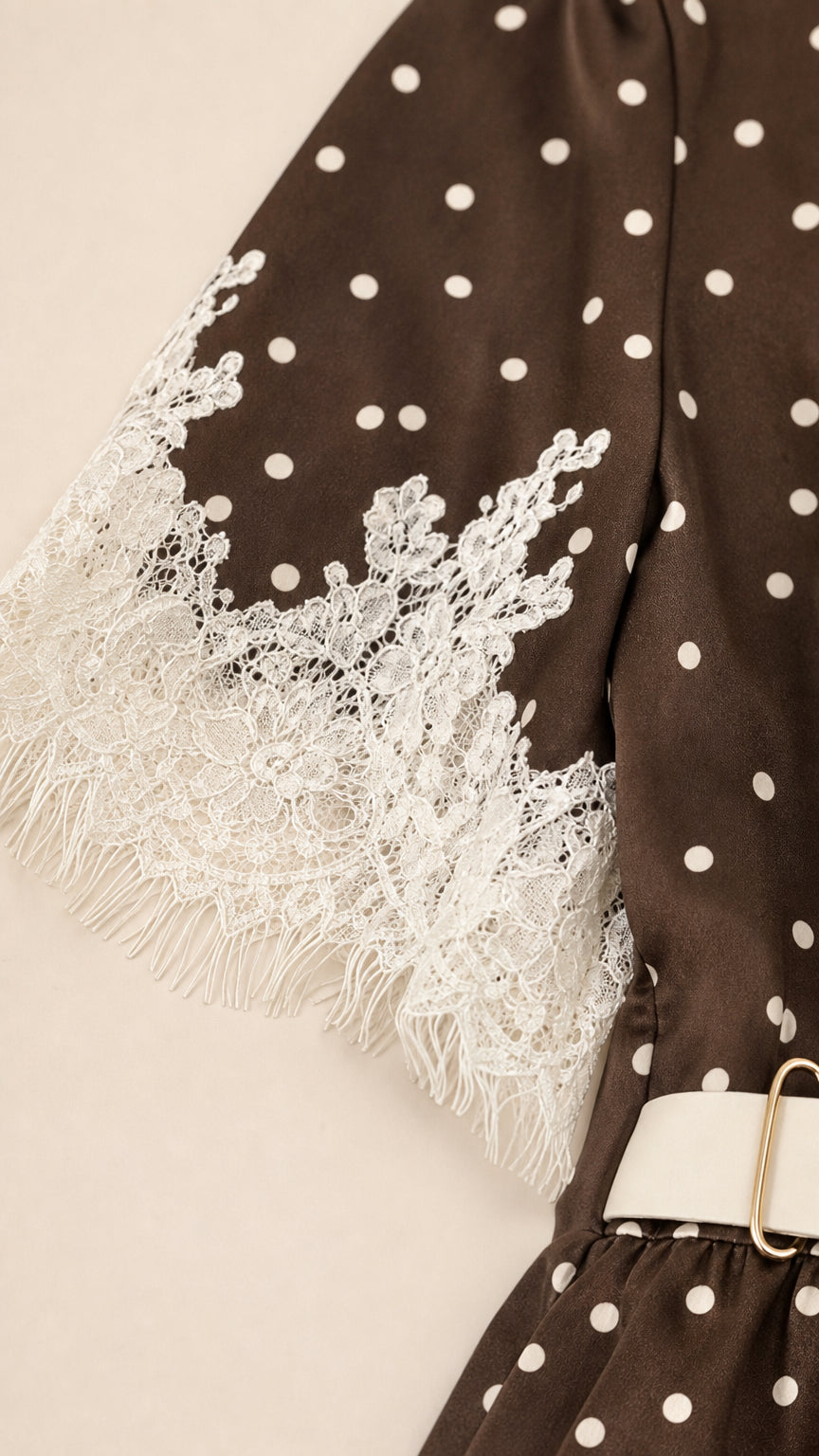 Close-up of lace hem detail on polka dot dress