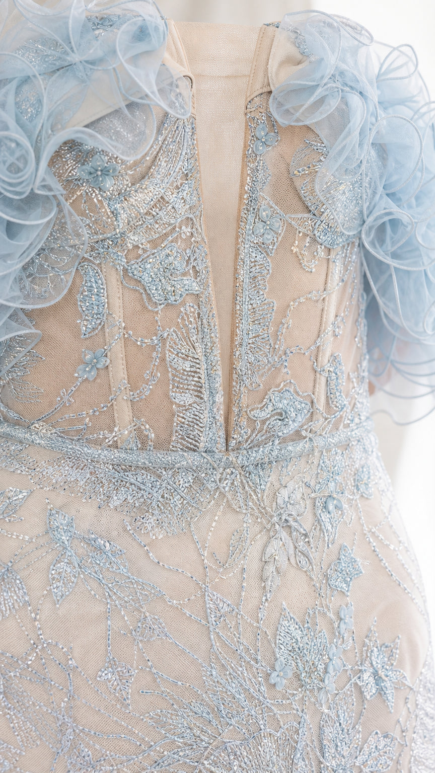 Close-up detail of illusion bodice and ruffle sleeves