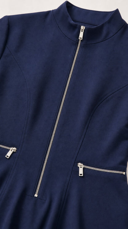 Close-up of mock neck and metallic zipper details on navy dress