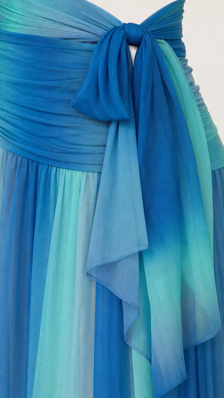 Close up of draped sash and chiffon fabric detail in blue