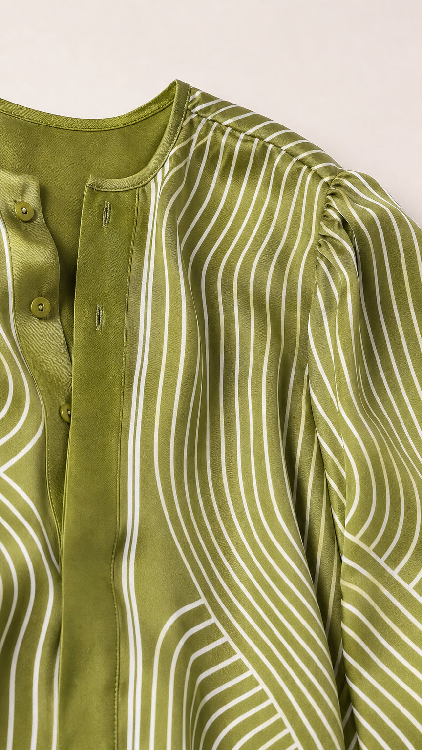 Close-up detail of olive satin blouse fabric and neckline