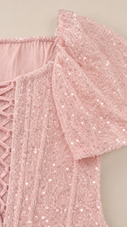 Close-up detail of Blush Pink sequined fabric texture and corset boning seamlines