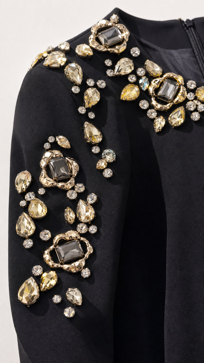 Close-up of sparkling crystal and gemstone embellishments on neckline and shoulder