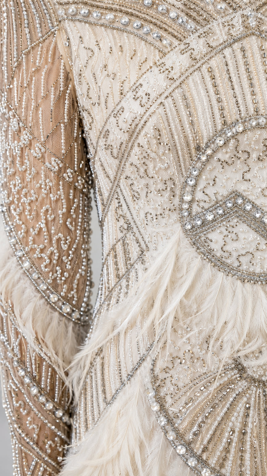 Close-up detail of crystal beadwork and feather sleeve trim