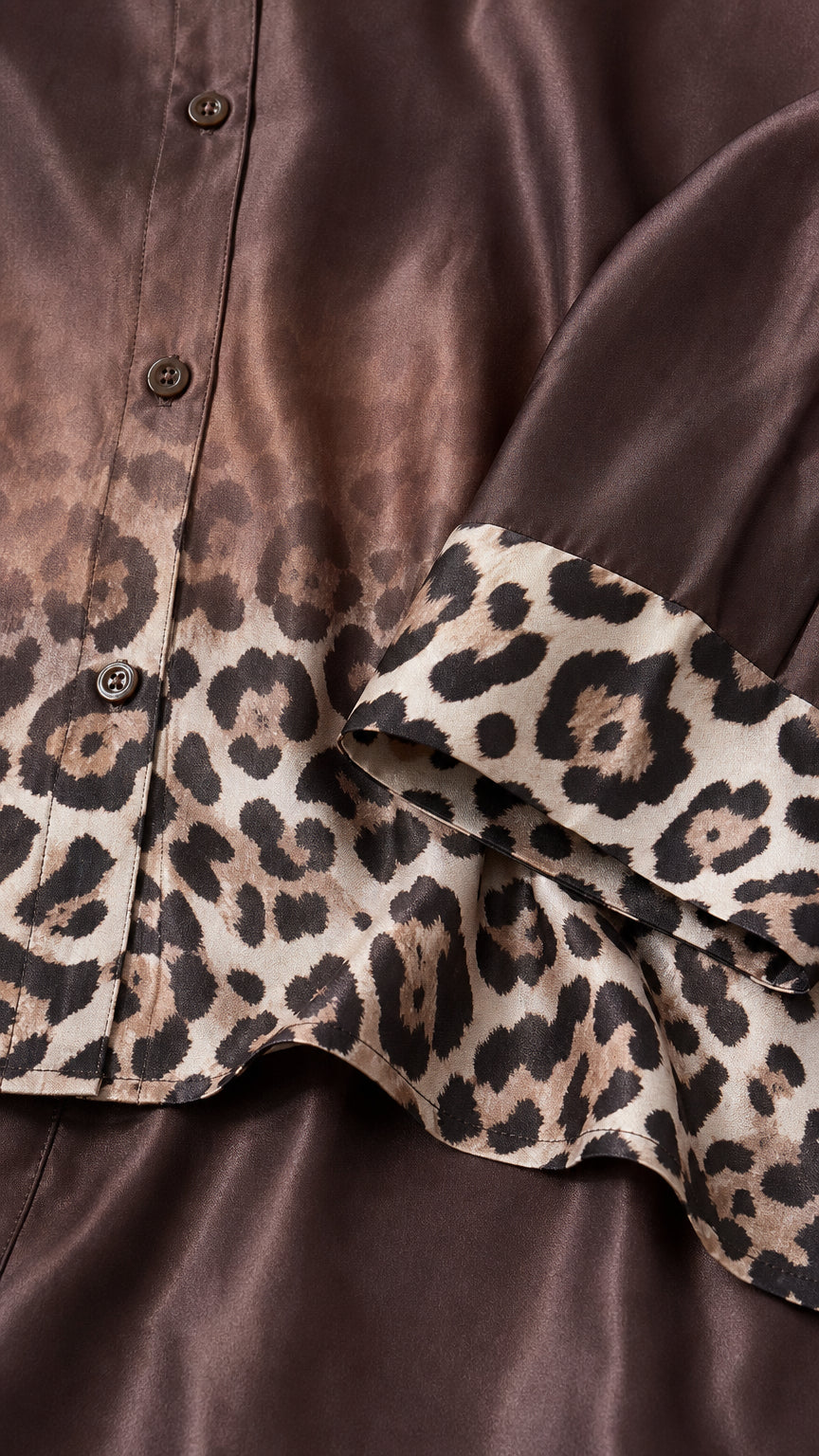 Close-up detail of smooth satin fabric and leopard print cuff