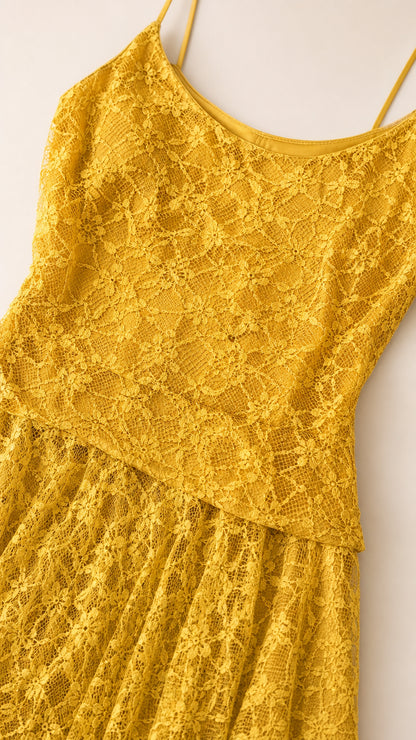 Close-up detail of textured floral lace fabric and drop-waist overlay