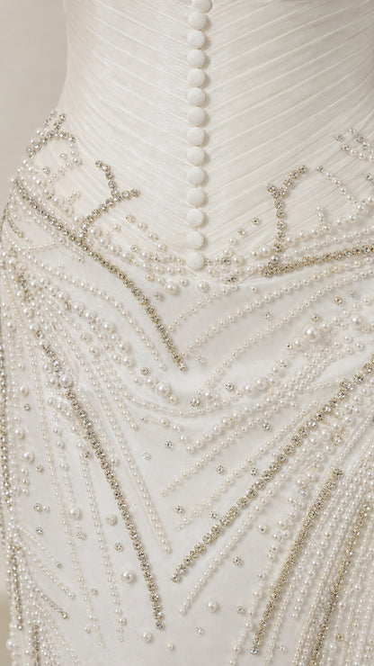 Close-up detail of pearl and crystal beadwork on the bodice and hip