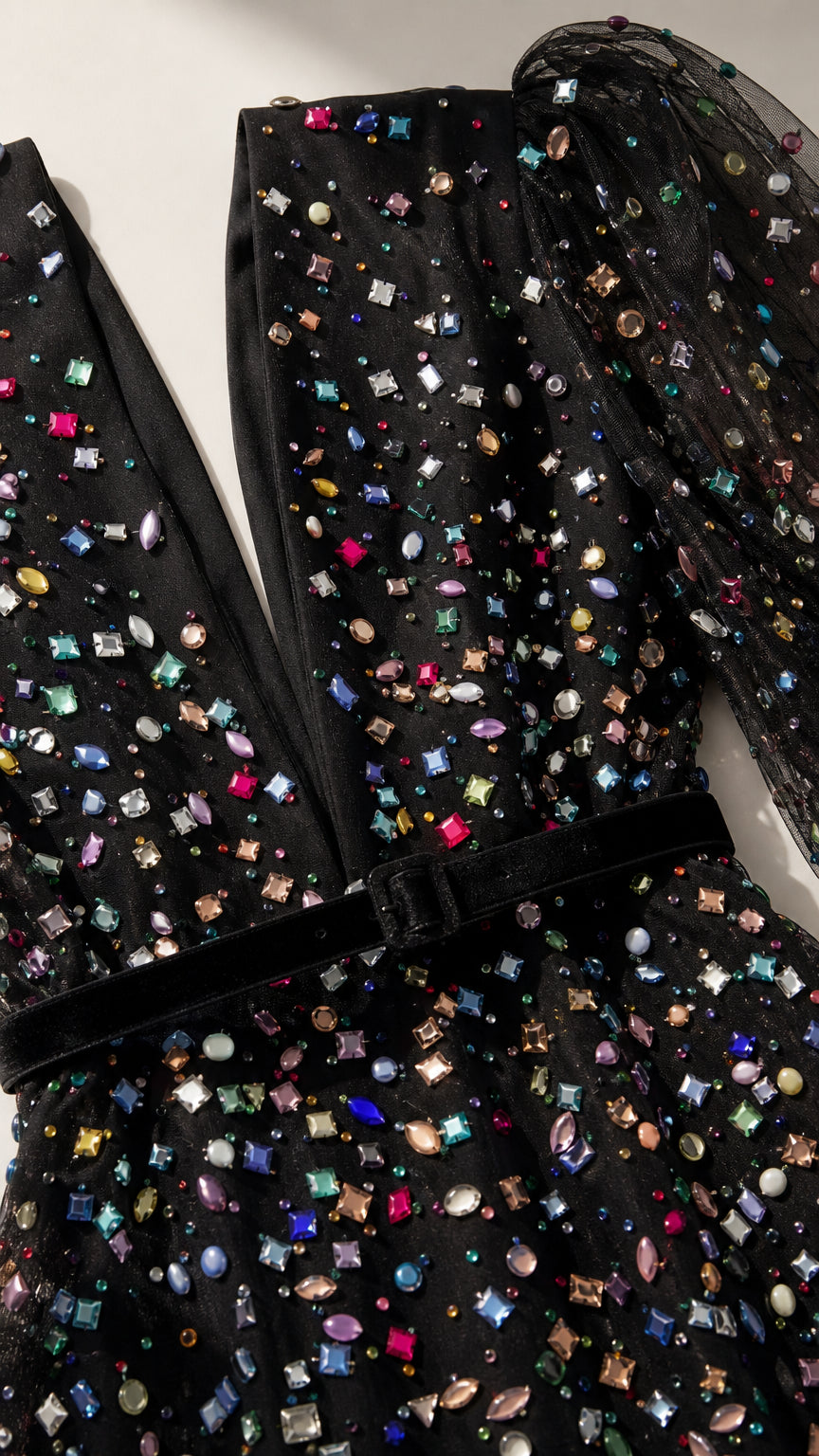 Close-up detail of multi-colored crystals and velvet waistband on black gown