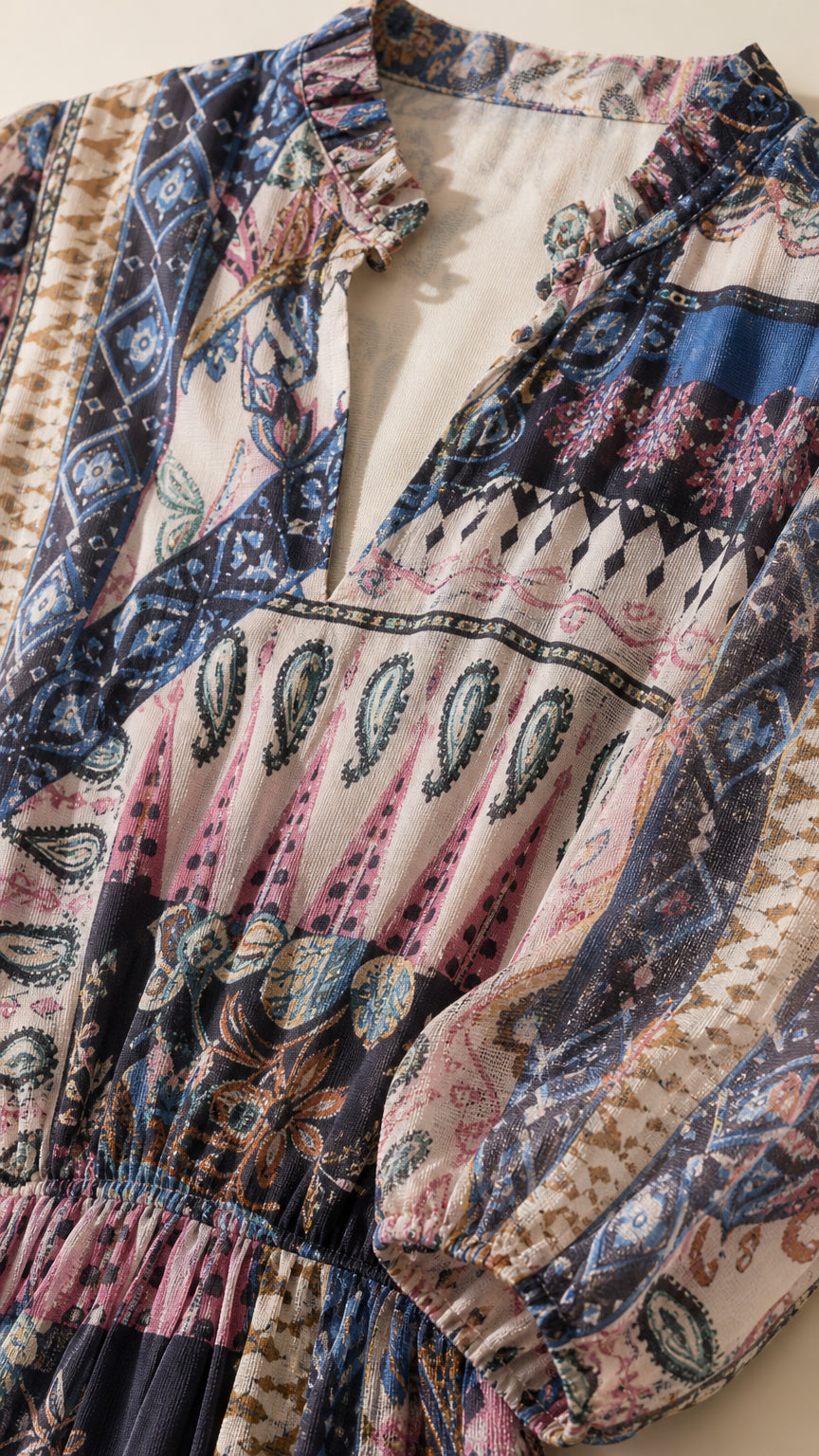 Close-up detail of the ruffled collar and mixed print pattern