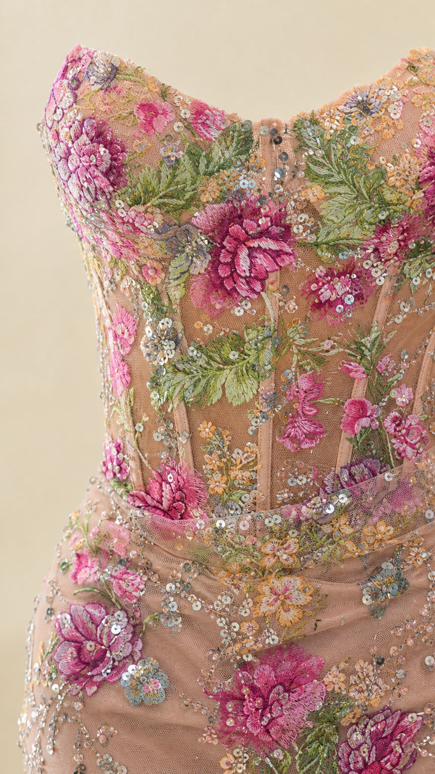 Close-up detail of floral embroidery, sequins, and corset boning