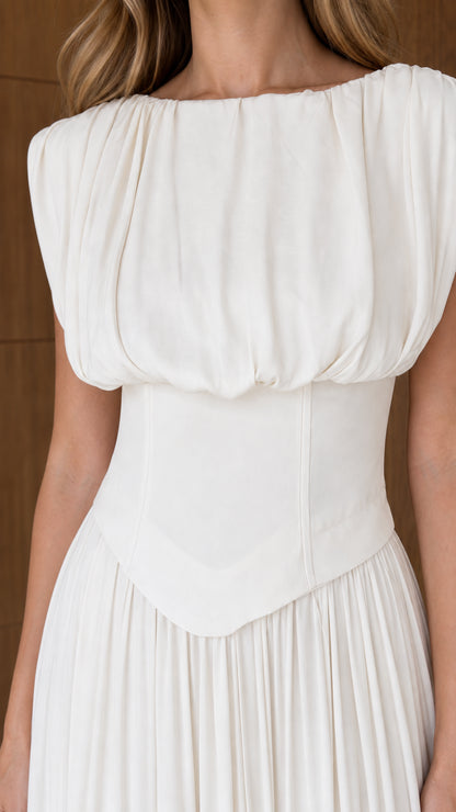 Close-up detail of white draped boatneck bodice and structured basque waist