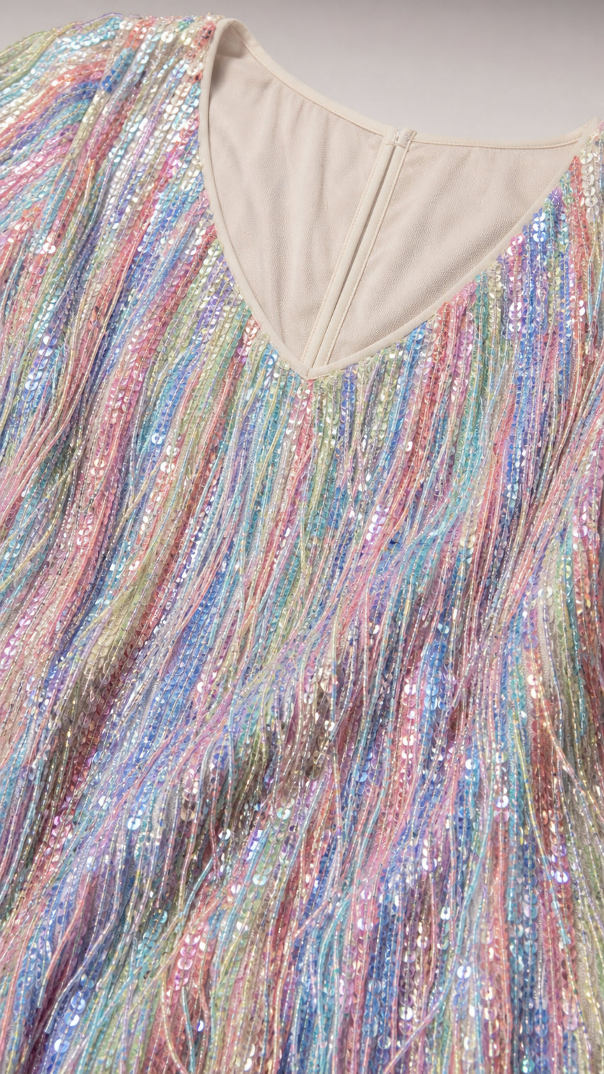 Close-up detail of V-neckline and multi-color sequin fringe texture