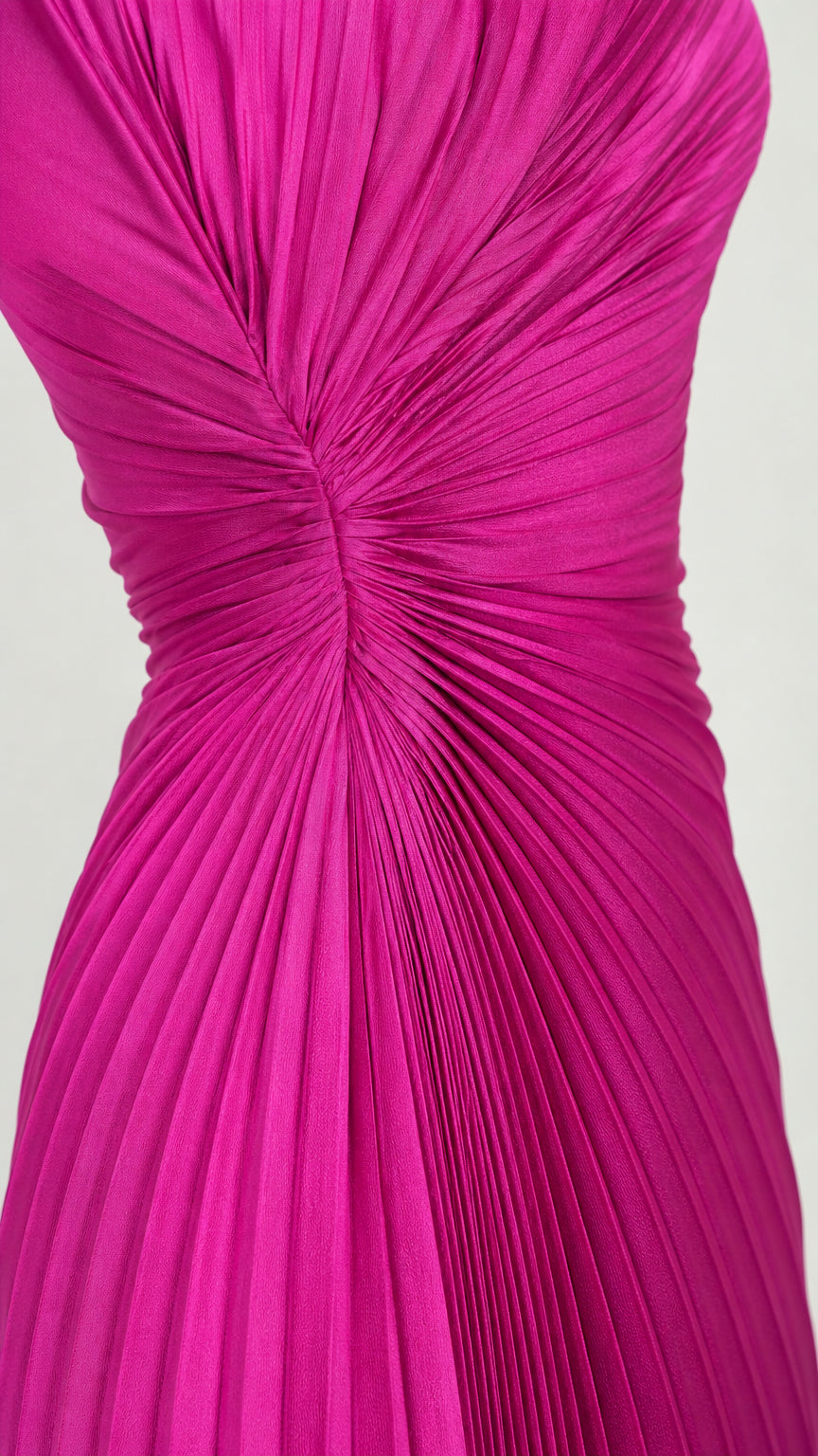 Close-up detail of gathered waist and pleating on fuchsia evening dress
